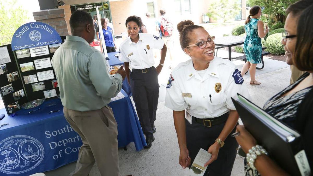 Lt. Regina Mays talks with Joan Hooks during a job fair in August at Midlands Technical College in Columbia. A pay raise for Corrections officers was included in both the S.C. House and Senate versions of the state budget that takes effect July 1.