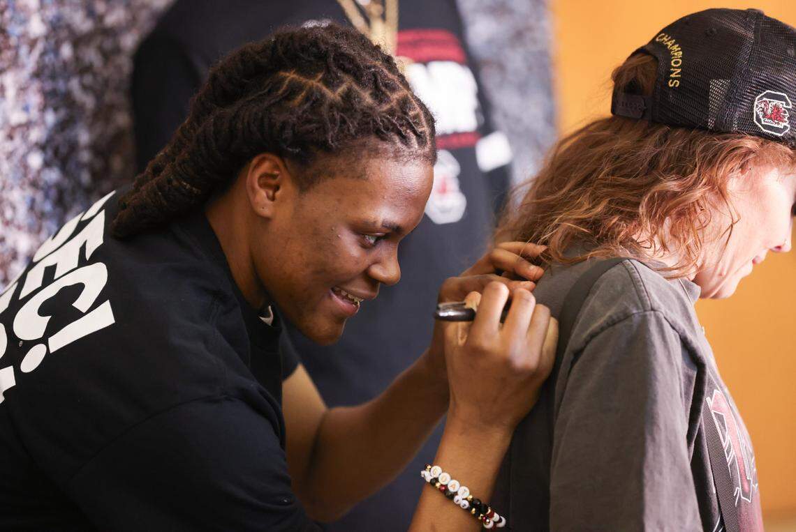 South Carolina guard MiLaysia Fulwiley (12) signs an autograph for a fan before the NCAA Selection Show for the Gamecocks’ at Colonial Life Arena in Columbia on Sunday, March 17, 2024.