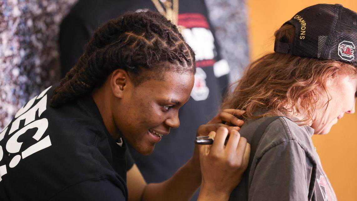 South Carolina guard MiLaysia Fulwiley (12) signs an autograph for a fan before the NCAA Selection Show for the Gamecocks’ at Colonial Life Arena in Columbia on Sunday, March 17, 2024.