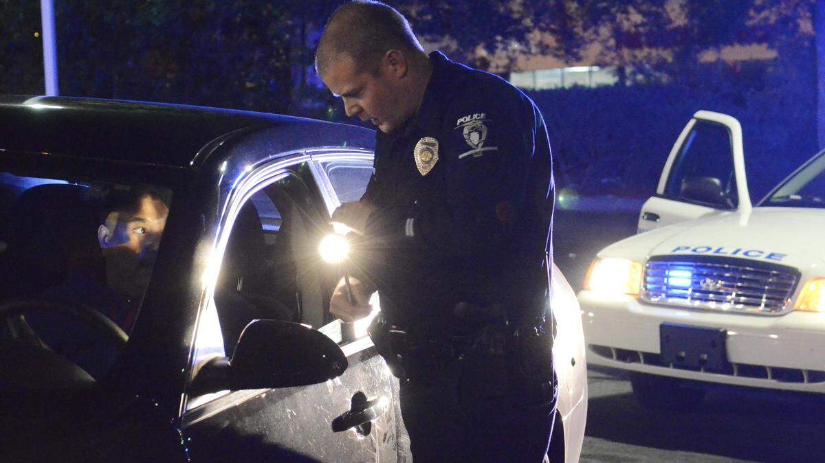In this file photo, a police officer talks with a motorist that he pulled over for speeding.