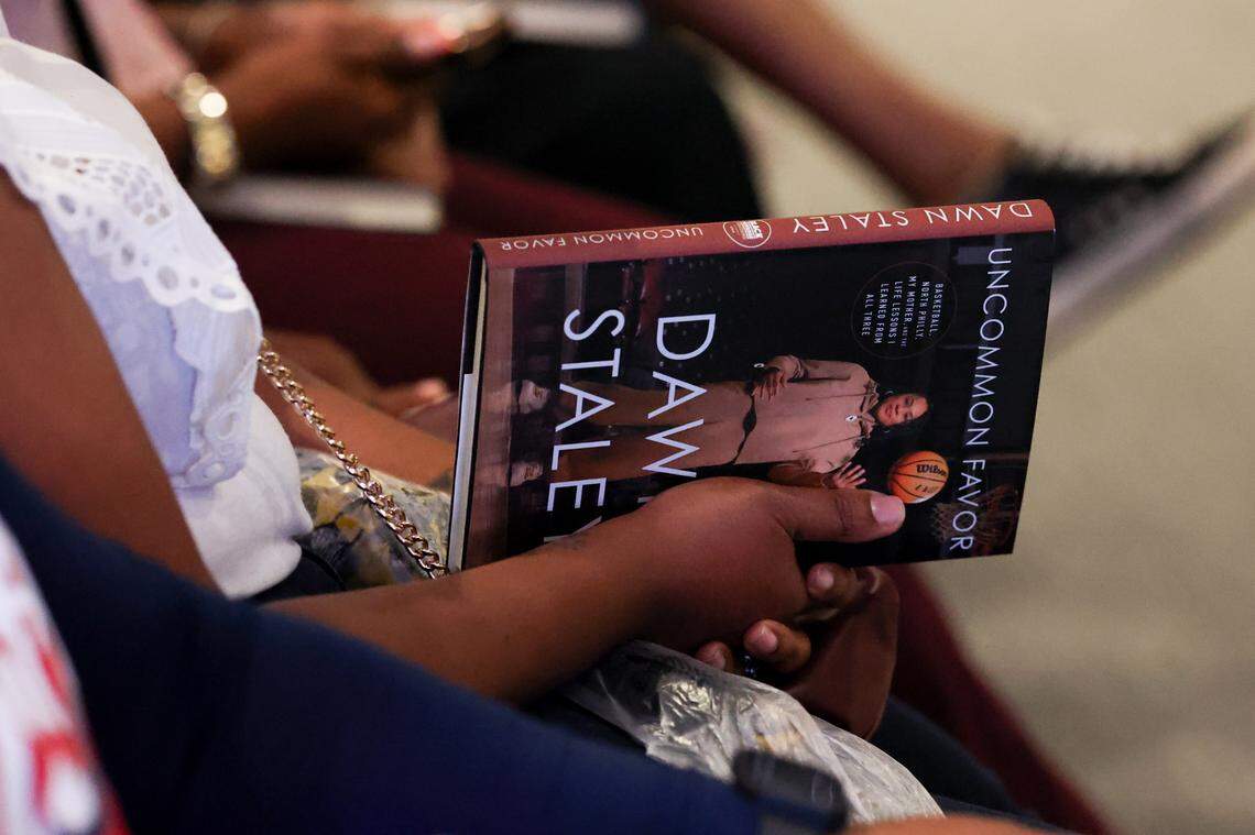 A fan holds a copy of University of South Carolina Head Coach Dawn Staley’s book, Uncommon Favor, during a book tour stop in Columbia on Thursday, May 29, 2025, at the R2i2 Conference Center.