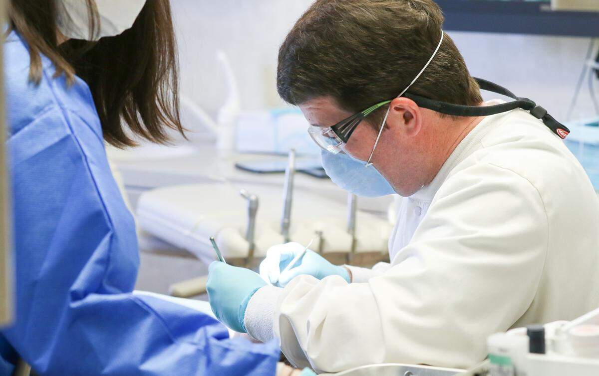 Eastern South Carolina dentist Kent Bracey works on a patient’s teeth in 2019. Like many South Carolina dentists, Bracey has said adding fluoride to public drinking water helps protect children’s teeth. He has seen first hand problems in the teeth of children who have not been raised on fluoridated water.