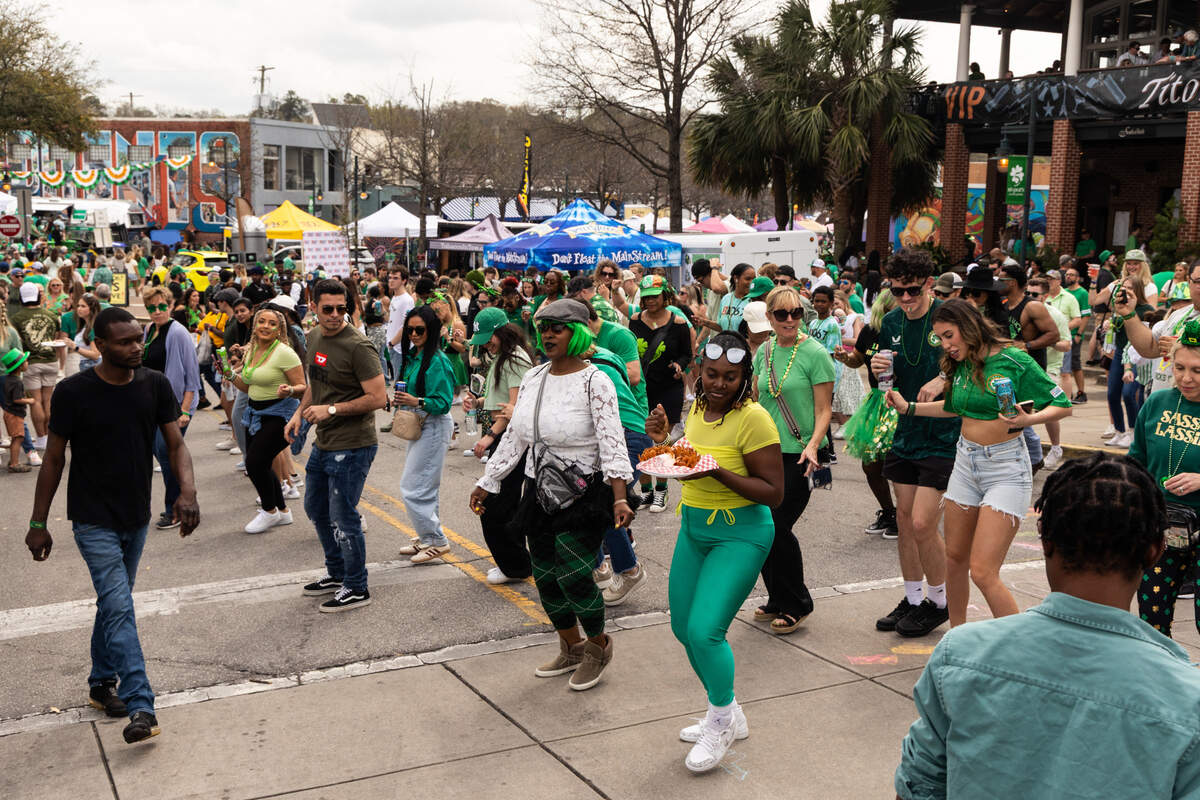 People dance to the Cupid Shuffle during the St. Pat’s in Five Points festival in Columbia, South Carolina on Saturday, March 15, 2025. In addition to live music, several DJs played music across the neighborhood.