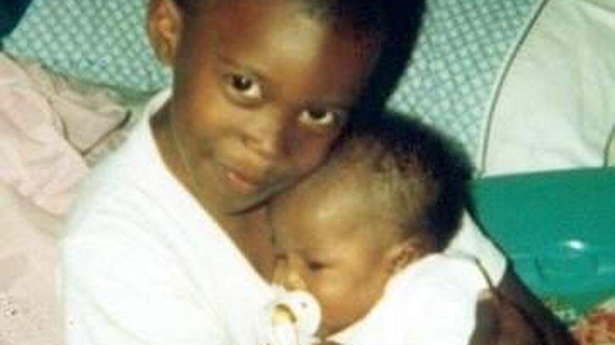 South Carolina cornerback Cam Smith (left) holds his infant sister Gabbie before her untimely death in 2006.