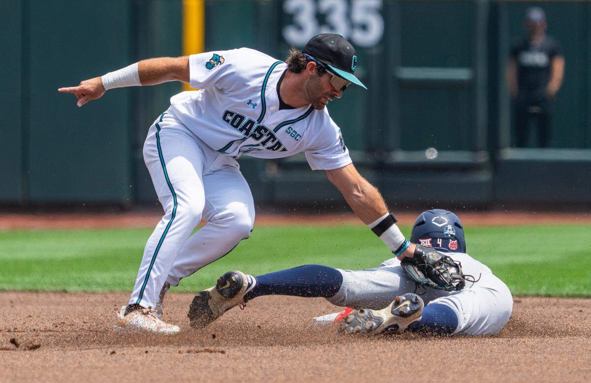 Coastal Carolina Chanticleers second baseman Blake Barthol (7) gets out Arizona Wildcats right fielder Brendan Summerhill (4) during the first inning at Charles Schwab Field.