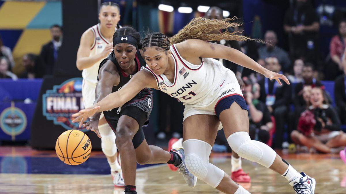 South Carolina's Raven Johnson (25) swipes the ball from University of Connecticut’s Sarah Strong (21) during the first half of action of their women's basketball game in the NCAA Tournament semifinals against UConn at Mortgage Matchup Center in Phoenix on Friday, April 3.2026. NCAA Tournament semifinals