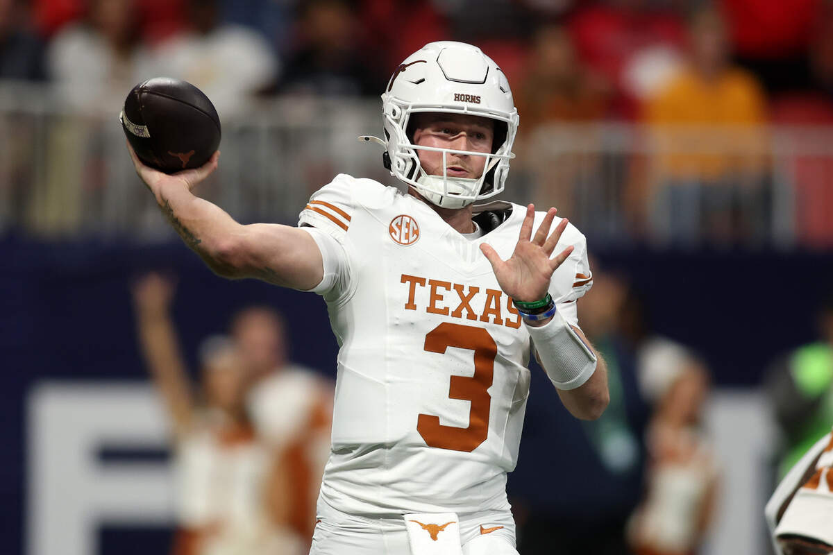 Dec 7, 2024; Atlanta, GA, USA; Texas Longhorns quarterback Quinn Ewers (3) drops back to pass against the Georgia Bulldogs during the first half in the 2024 SEC Championship game at Mercedes-Benz Stadium.