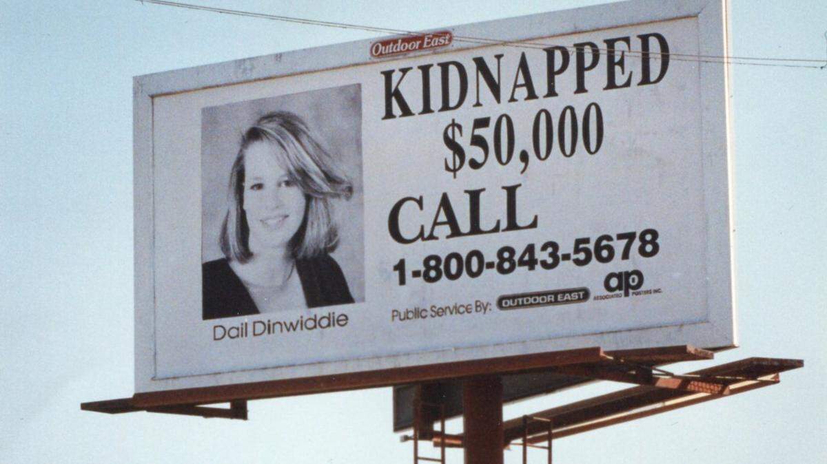 A billboard posted in the 1990s offers a reward for information about the disappearance of Dail Dinwiddie.