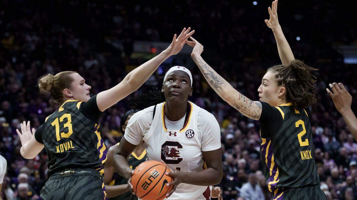 South Carolina center Madina Okot (11) looks to shoot around LSU forward Kate Koval (13) and LSU forward Grace Knox (2) during the first half of an NCAA basketball game Saturday, Feb. 14, 2026, at Pete Maravich Assembly Center in Baton Rouge, La.