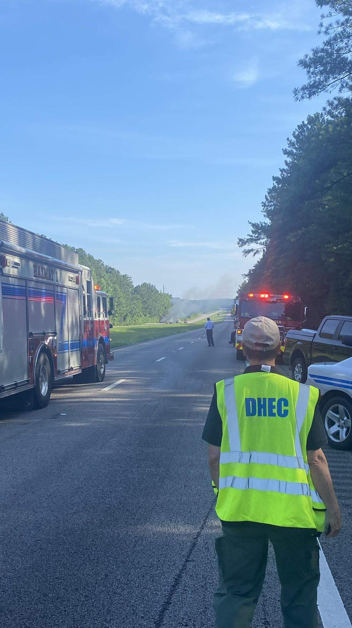 Emergency responders at the scene of a car crash that caused a fire and a hazardous material spill on a highway running through the Midlands.