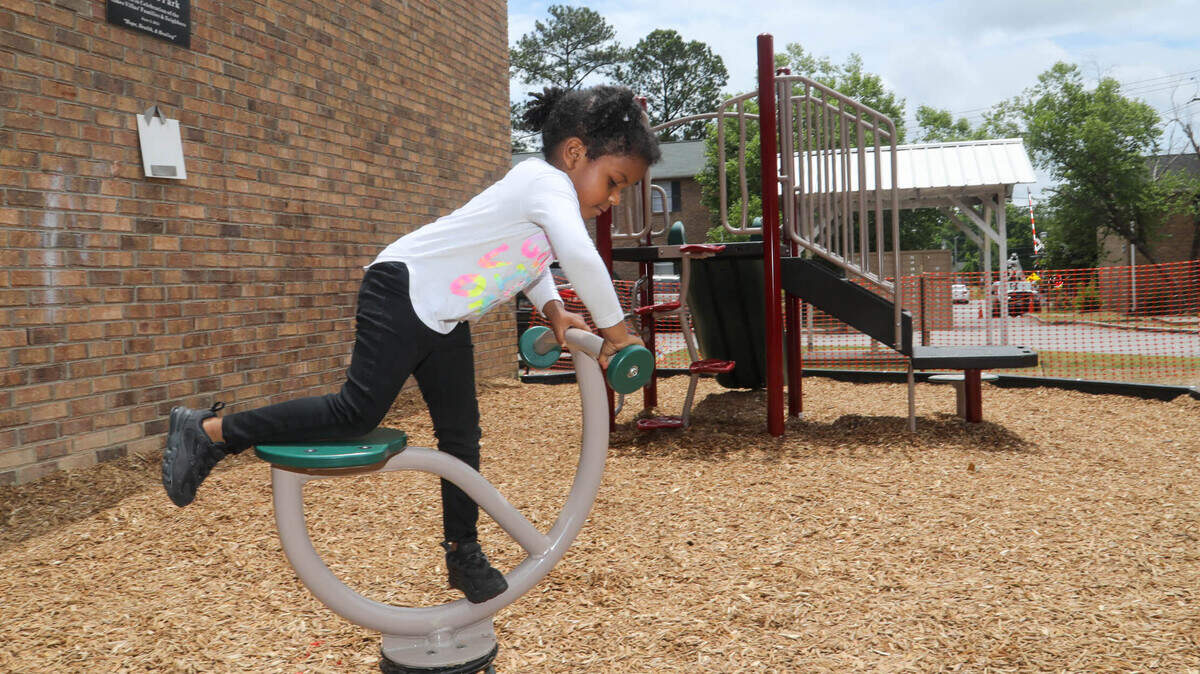 Faith Callaham, 3, plays in the new park at Ames Villas in Columbia. The park, named in honor of John E. Moore, is part of a community initiative to improve the quality of life in the complex.