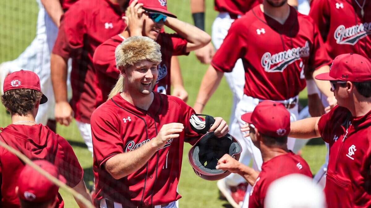 South Carolina Gamecocks outfielder Andrew Eyster (11) wears a coonskin cap put after his home run against the Alabama Crimson Tide during their game at Founders Park in Columbia, SC, Saturday, April 30, 2022.
