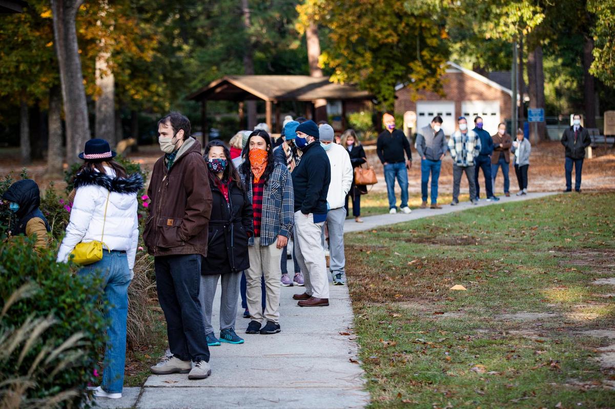 Voters wait outside the Sims Park voting location on Tuesday, November 3, 2020. Voters exiting the polls said they waited in line for less than an hour.