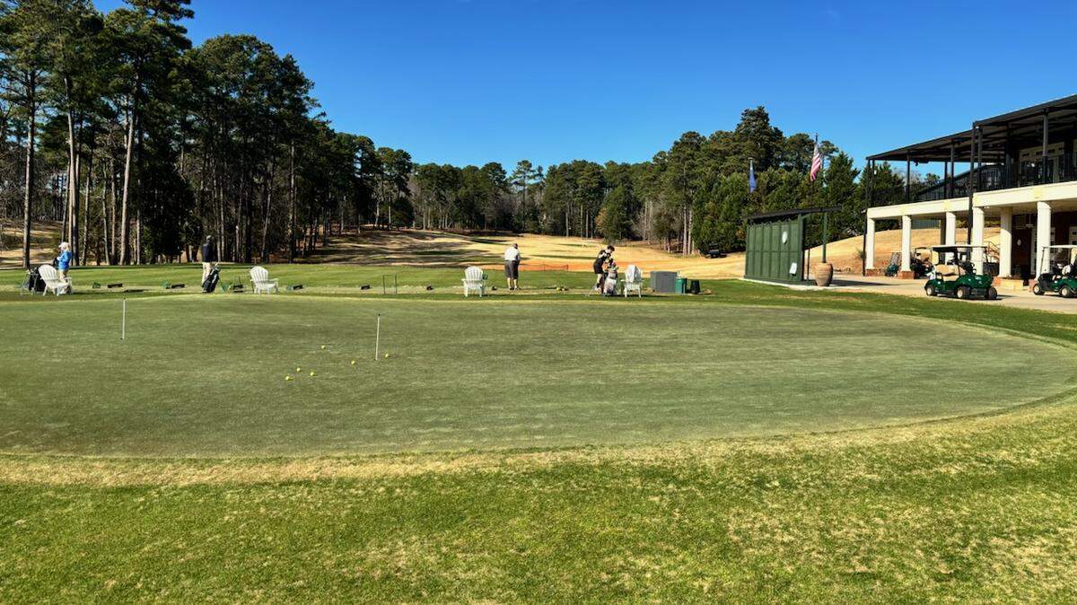 Timberlake Country Club’s practice green with the driving range in the background