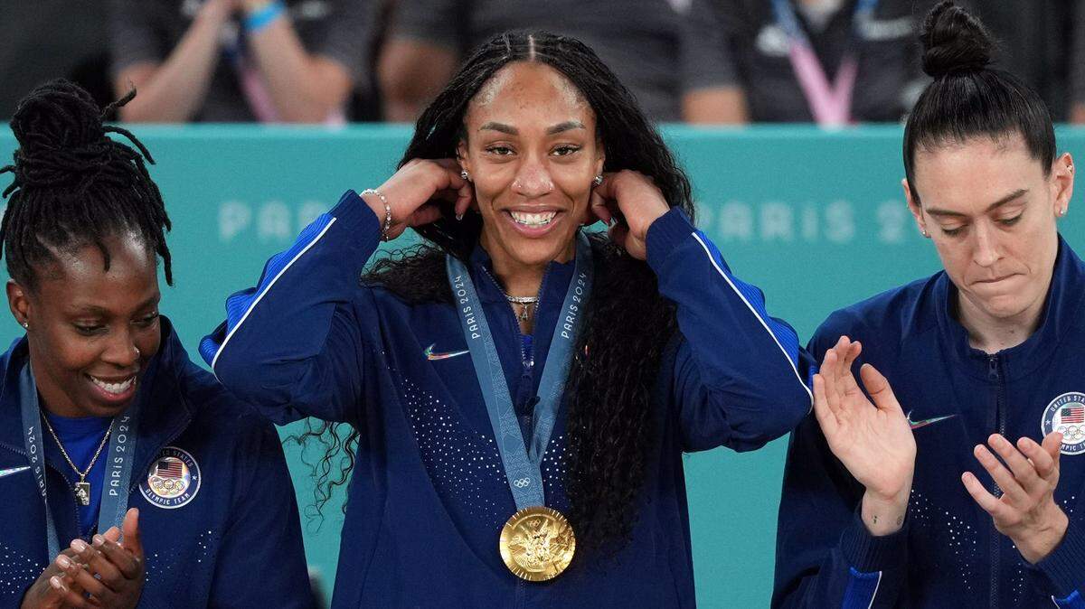 United States forward A’Ja Wilson (9) celebrates on the podium after defeating France in the women’s basketball gold medal game during the Paris 2024 Olympic Summer Games at Accor Arena.