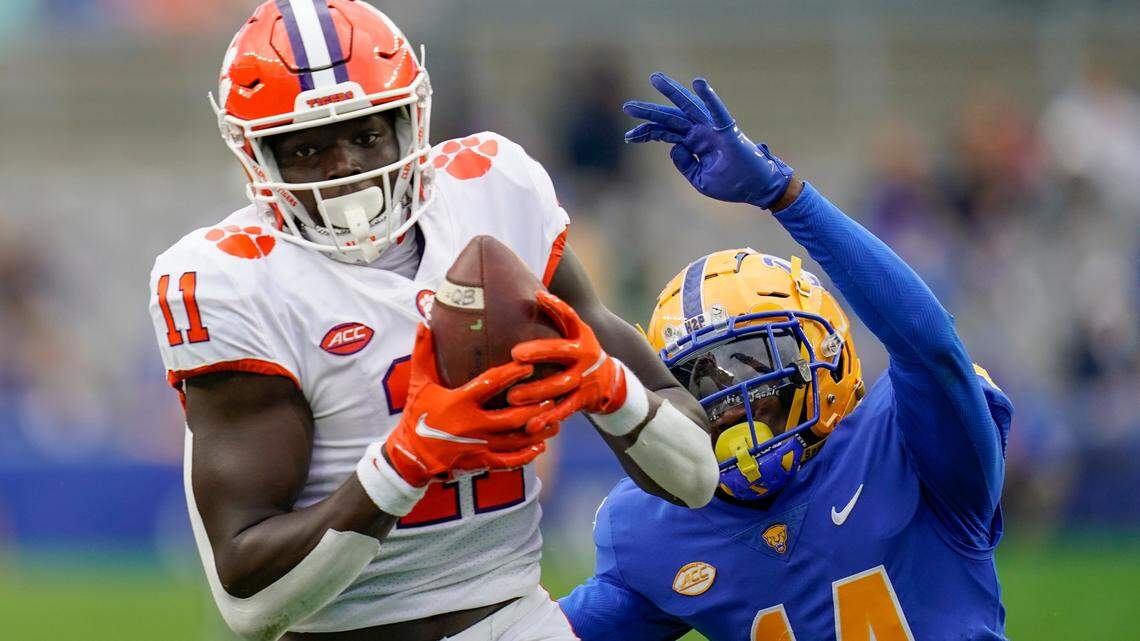 Clemson wide receiver Ajou Ajou (11) makes a catch past Pittsburgh defensive back Marquis Williams (14) during the first half of an NCAA college football game, Saturday, Oct. 23, 2021, in Pittsburgh. (AP Photo/Keith Srakocic)