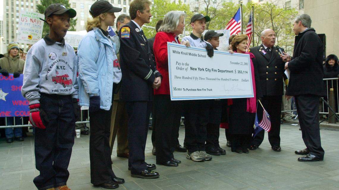 During Thursday’s “Today” morning news show, NBC anchor David Bloom, far right, interviews Columbia Fire Chief John Jansen , second from right, as White Knoll Middle School students Staci Smith, Leigh Tyson, Thomas Dunn and Maurice Hallman, South Carolina State Superintendent of Education Inez Tenenbaum ( to the left of Chief Janzen), White Knoll Middle School Principal Dr. Nancy Turner (in red jacket) prepare to present a check for $353,114 to present NYFD Red Hook fire station Captain Tom Giordano in New York City on Thursday 11/22/2001. The students traveled with a delegation from South Carolina to give more than $447,000 to replace a fire truck destroyed in the Sept. 11 terrorist attacks. Erik Campos/The State