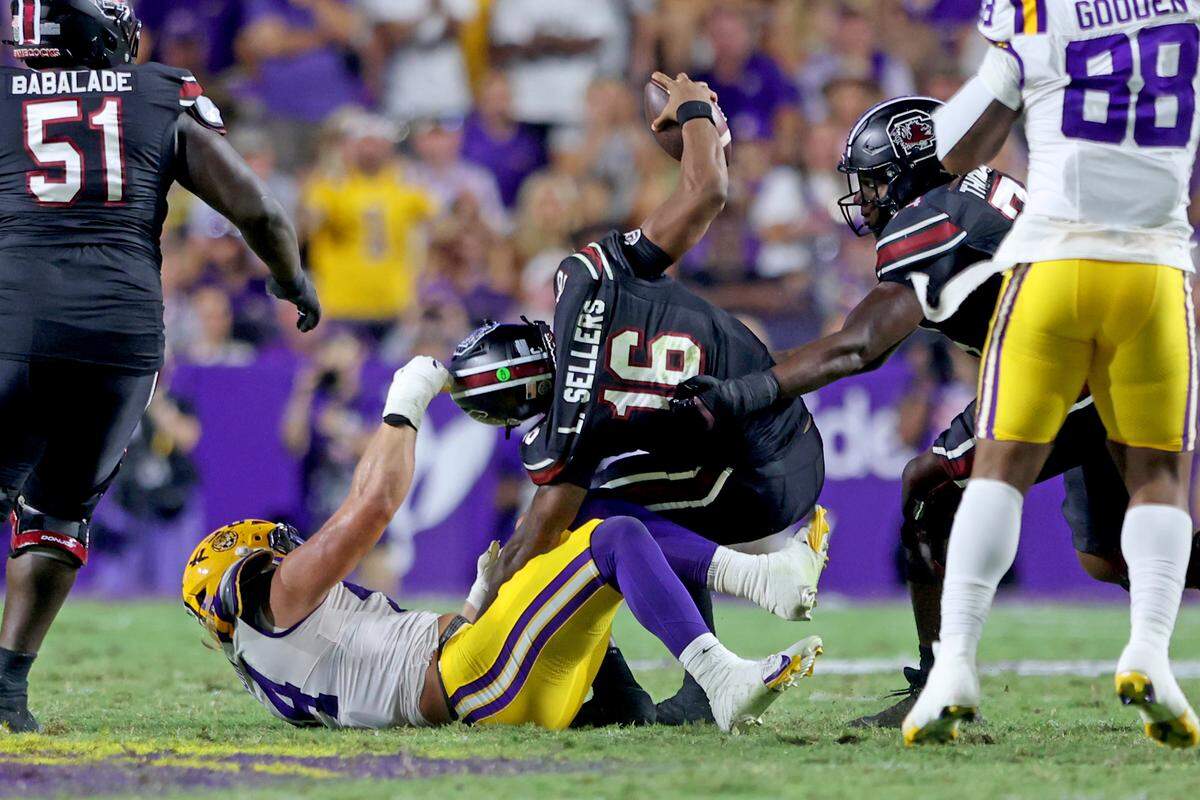 Defensive end Jack Pyburn #44 of the Louisiana State Tigers sacks quarterback Lanorris Sellers #16 of the South Carolina Gamecocks for a 9-yard loss in the second quarter at Tiger Stadium on October 11, 2025 in Baton Rouge, Louisiana.