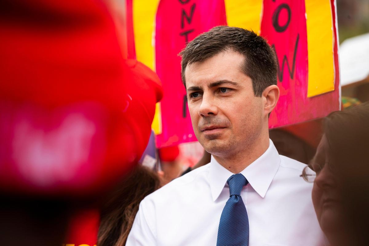 Former South Bend, Indiana Mayor Pete Buttigieg listens to De’Aysa Davis, a striking McDonald’s worker in Charleston, South Carolina on Monday, February 24, 2020. Buttigieg marched with the workers and activists who are striking for higher wages and the ability to unionize.