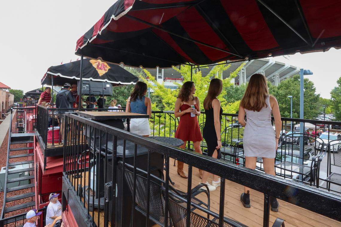 People mingle on Cockabooses before USC plays LSU on Saturday, Sept. 14, 2024. A line of 22 vintage railroad cabooses form the Cockaboose Railroad near the Williams-Brice Stadium. The Cockabooses are privately owned a used mainly for tailgating.