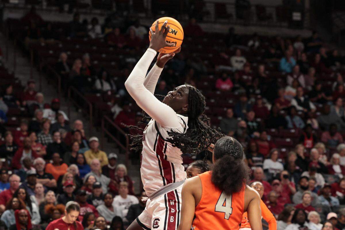 University of South Carolina forward Adhel Tac (15) shoots as Clayton State’s India Dowling-Green (4) pressures during the second half of action in the Colonial Life Arena on Monday, Oct. 28, 2024.