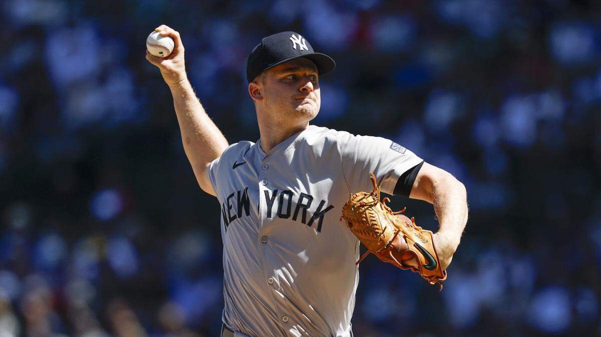 New York Yankees starting pitcher Clarke Schmidt (36) delivers a pitch against the Chicago Cubs during the first inning at Wrigley Field.