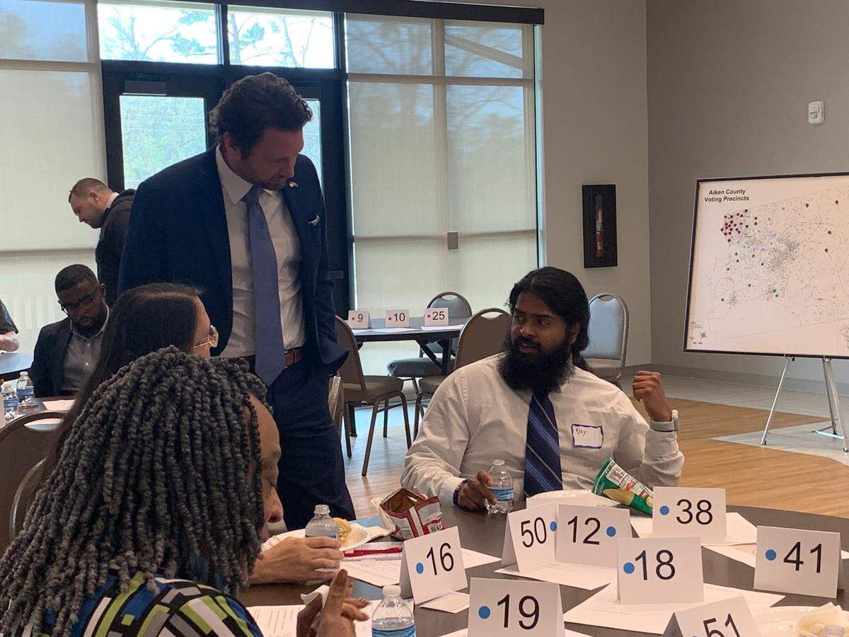 Former South Carolina Congressman, and Democratic gubernatorial candidate, Joe Cunningham speaks to Ajay Krishnakumar, of Aiken during the Aiken County Democratic Party convention on Saturday March 5, 2022.