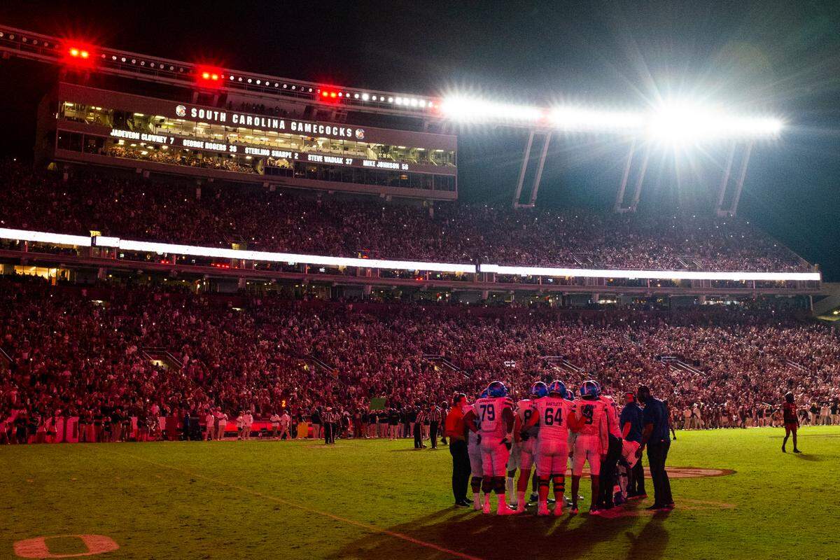 Georgia State huddles as lights flash on and off, white and red, during their game against South Carolina at Williams-Brice Stadium in Columbia, SC on Saturday, Sept. 3, 2022.