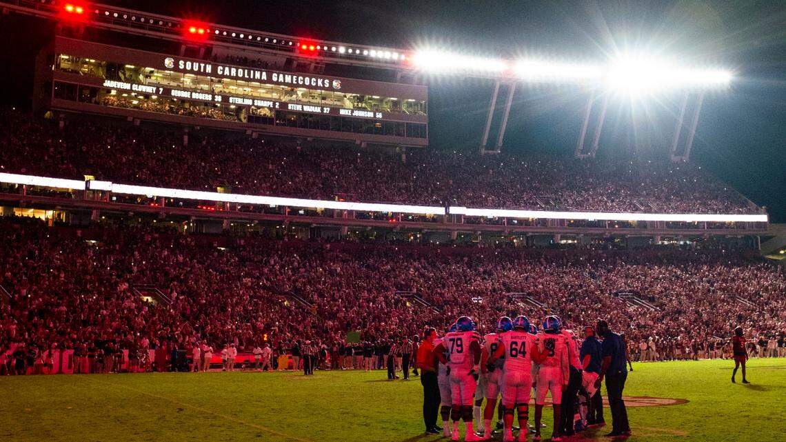Georgia State huddles as lights flash on and off, white and red, during their game against South Carolina at Williams-Brice Stadium in Columbia, SC on Saturday, Sept. 3, 2022.
