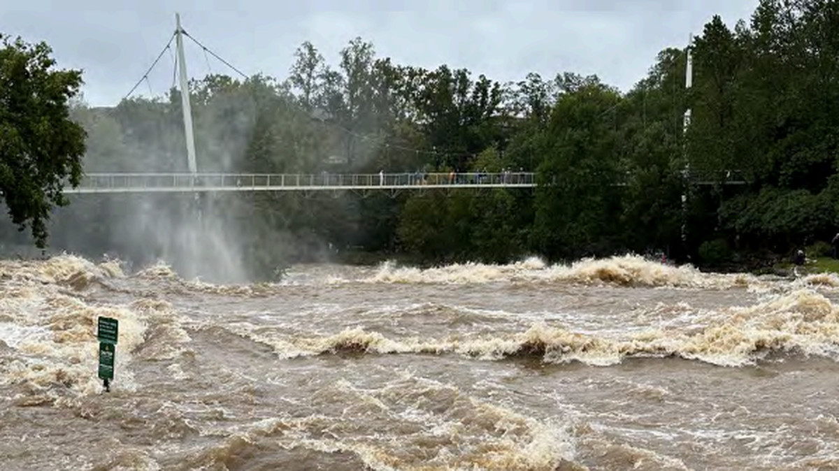 With Liberty Bridge in the background, the Reedy River courses through Greenville.