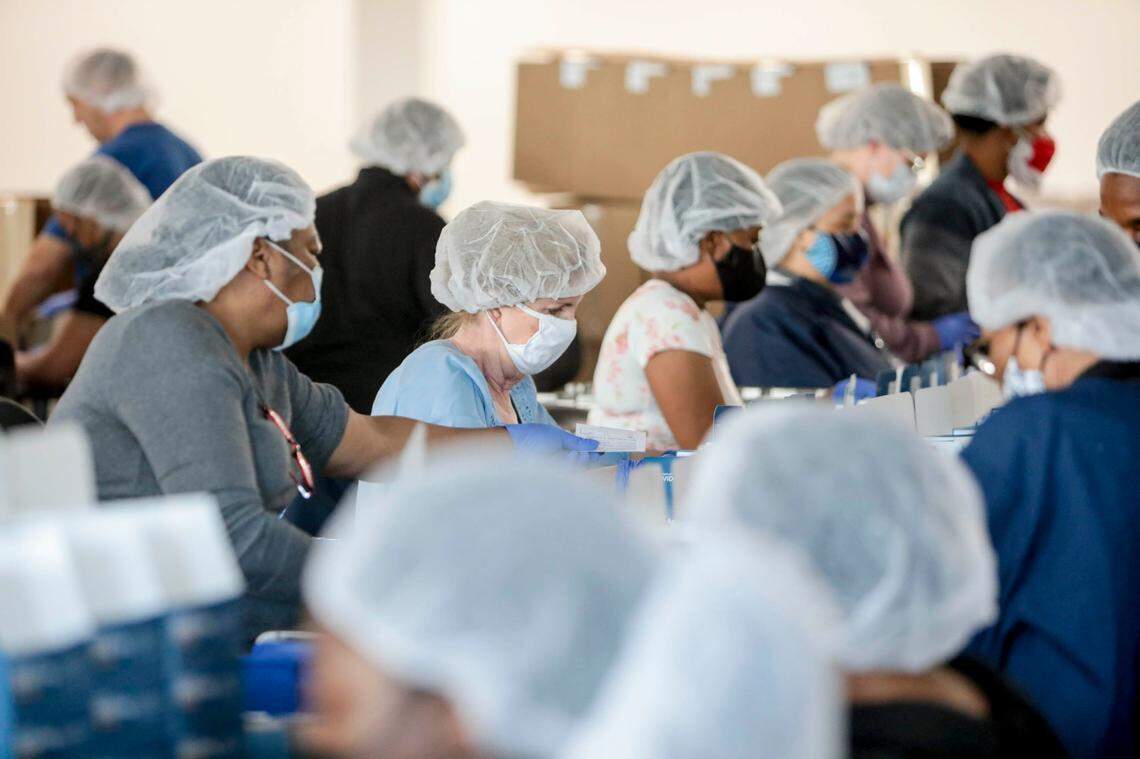 Employees assemble at-home Coronavirus testing kits at Nephron Pharmaceuticals in Lexington. 2,900 part-time employees were recently hired at the plant to meet demand.