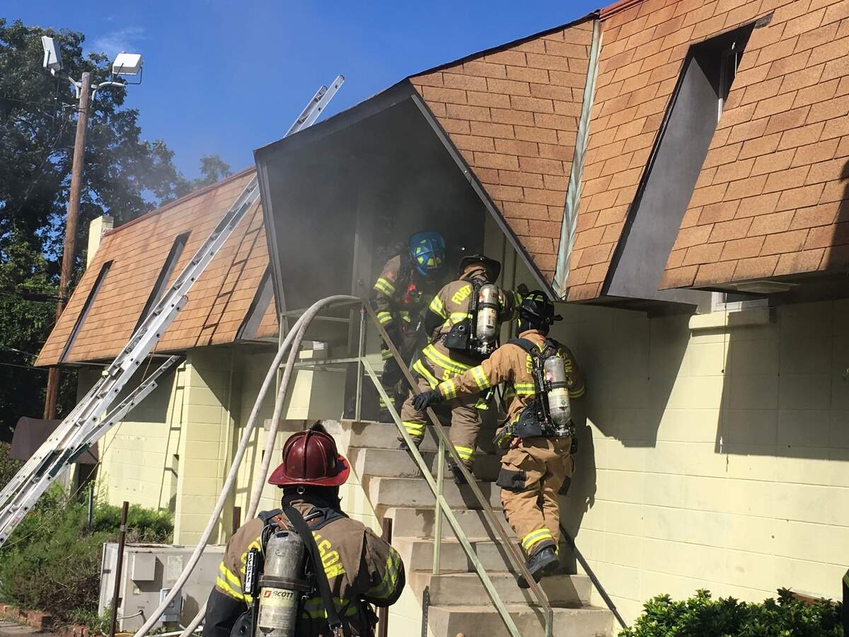 Fort Jackson Fire Department crews enter a building during a training drill with Columbia Fire Department.