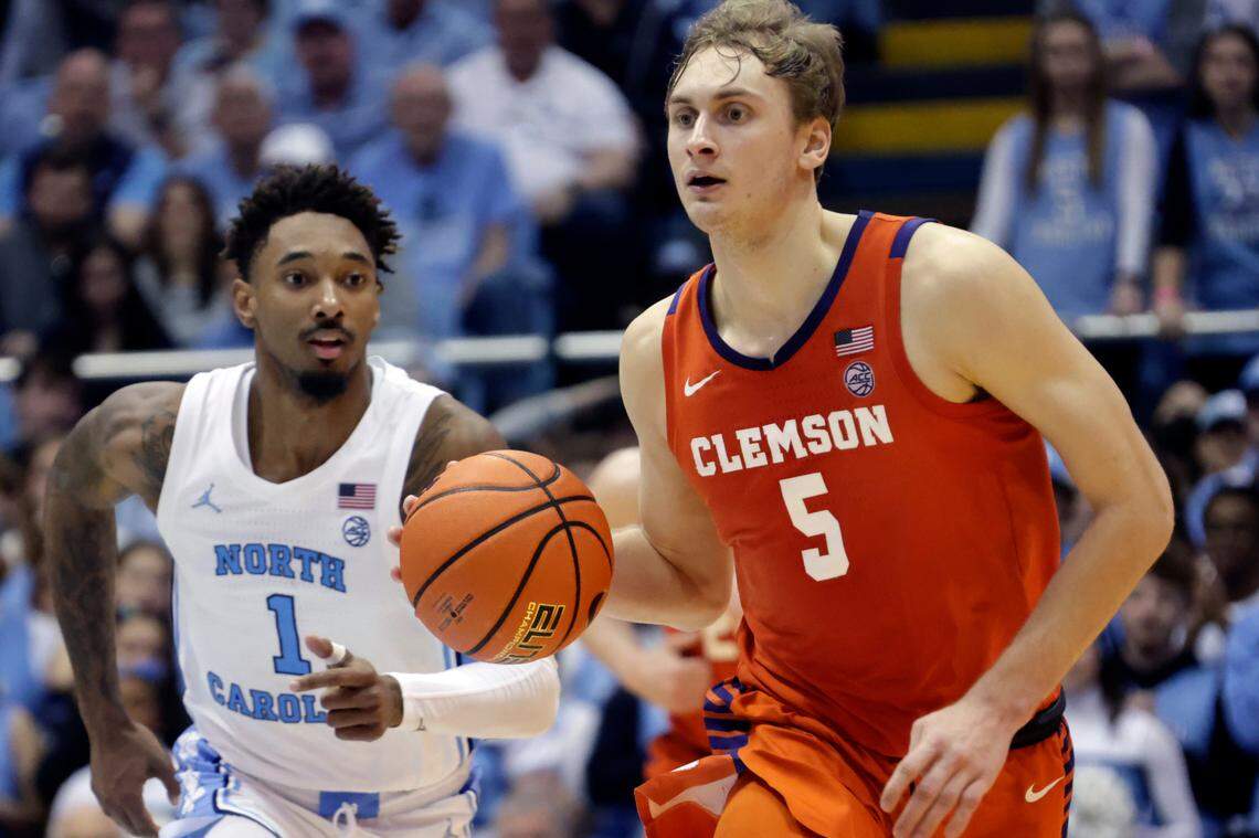 Clemson forward Hunter Tyson (5) brings the ball up with North Carolina forward Leaky Black (1) in pursuit during the second half of an NCAA college basketball game, Saturday, Feb. 11, 2023, in Chapel Hill, N.C.