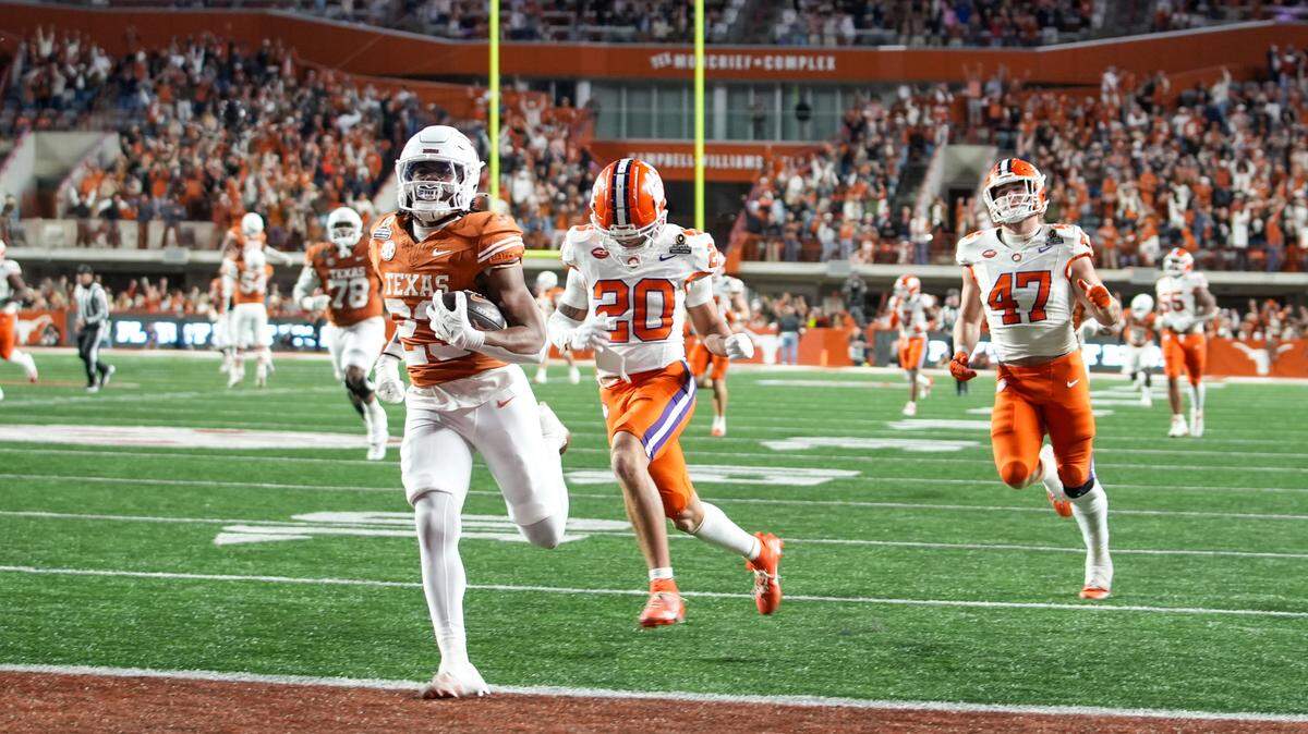 Dec 21, 2024; Austin, Texas, USA; Texas Longhorns running back Jaydon Blue (23) runs into the endzone for a touchdown against Clemson Tigers cornerback Avieon Terrell (20) and linebacker Sammy Brown (47) in the second half at Darrell K Royal Texas Memorial Stadium.