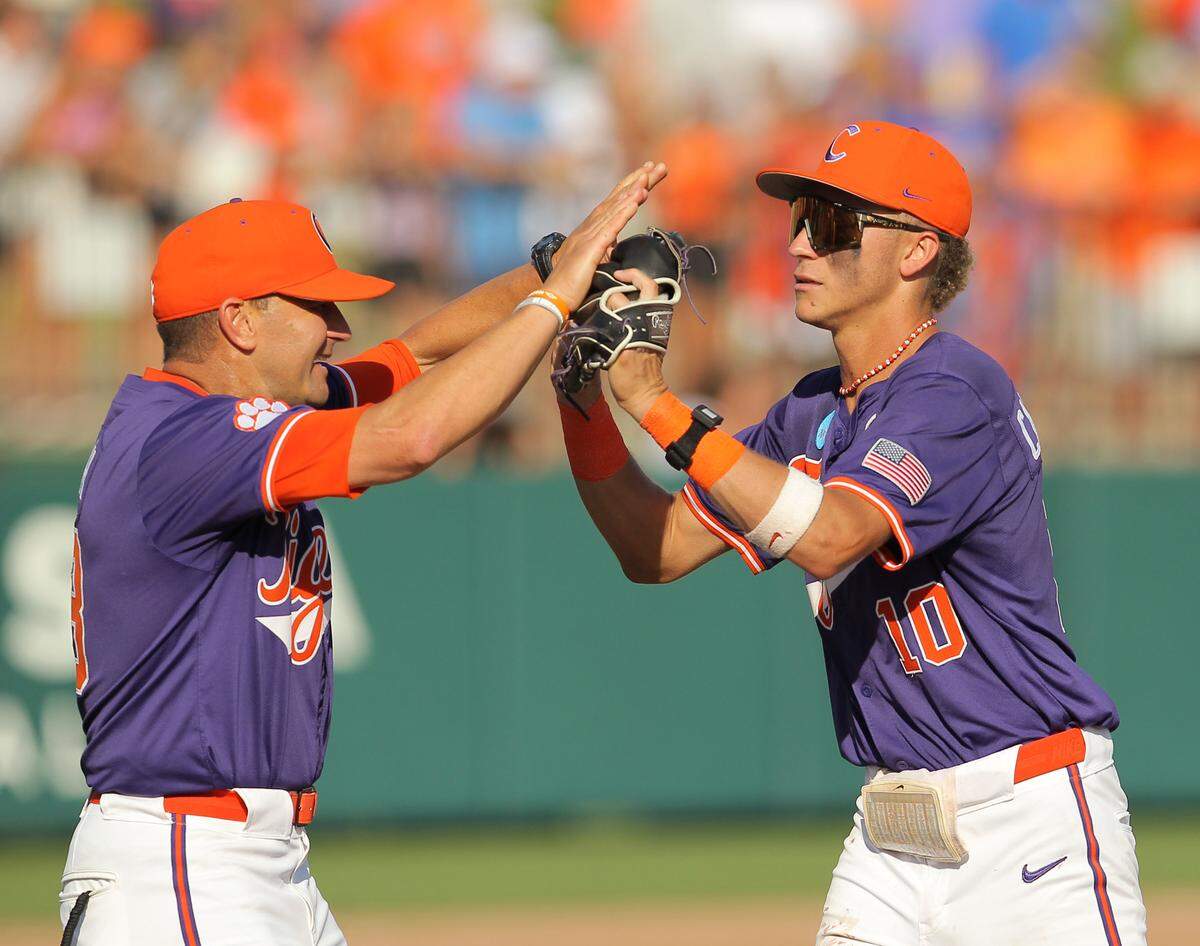 Clemson’s Cam Cannarella is congratulated by Clemson head coach Erik Bakich after he made a big defensive play against Florida during NCAA Super Regionals action on Sunday, June 9, 2024 in Clemson, S.C.