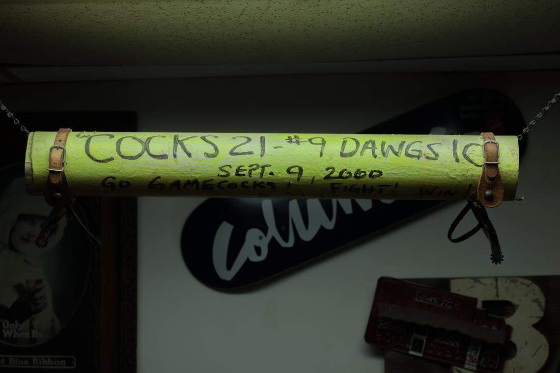 A section of the USC goal post that was carried to Five Points in 2000 when USC beat Georgia is displayed at Bar None. It is signed by then USC football coach Lou Holtz.