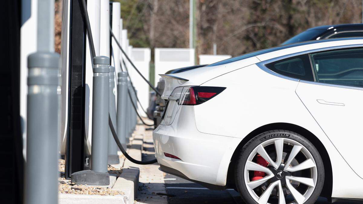 Electric vehicles park at a charging station.