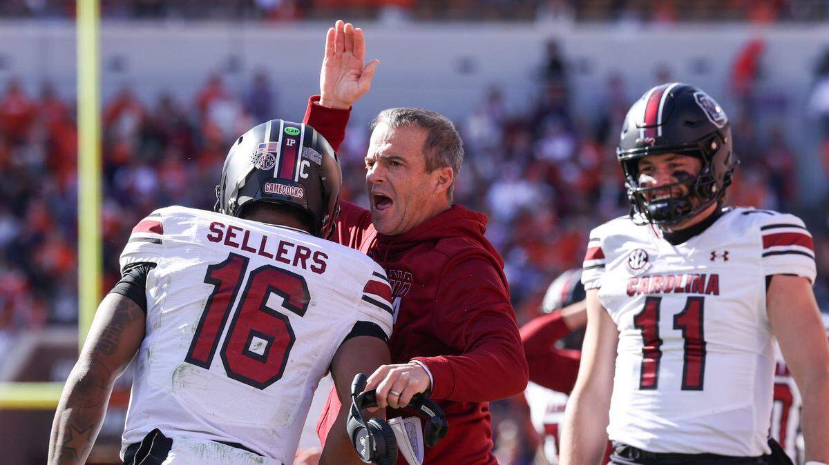 South Carolina head coach Shane Beamer congratulates quarterback LaNorris Sellers (16) on a touchdown during the Palmetto Bowl between at Memorial Stadium in Clemson on Saturday, November 30, 2024.