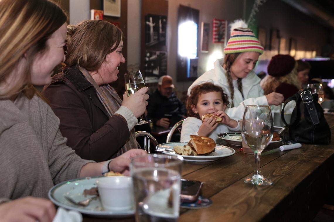 Sadie Moulton, from left, Elizabeth Cavalluzzi, Gigi Cavalluzzi, 3, and Kylie Cavalluzzi dine at The Keg Cowboy on Lexington’s Main Street before going to the market at the Icehouse Amphitheater on Friday Dec. 6, 2024.
