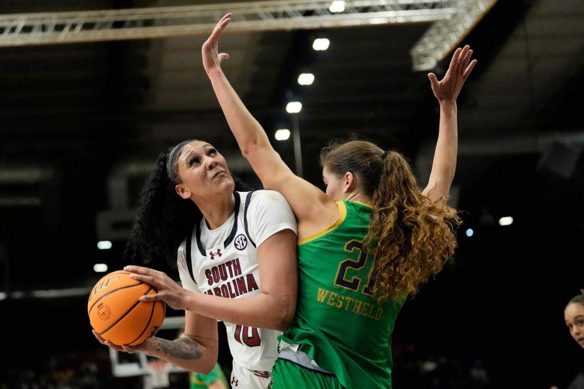 South Carolina center Kamilla Cardoso (10) is defended by Notre Dame forward Maddy Westbeld (21) during the first half of an NCAA college basketball game Monday, Nov. 6, 2023, in Paris. (AP Photo/Thibault Camus)