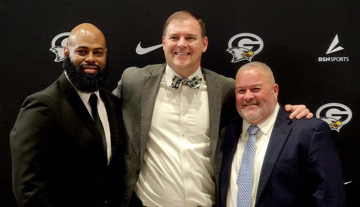 From left to right: New Gray Collegiate football coach De’Angelo Bryant, principal Brian Newsome and new athletic director Kevin Heise pose for a photo at a press conference on Feb. 13, 2024.