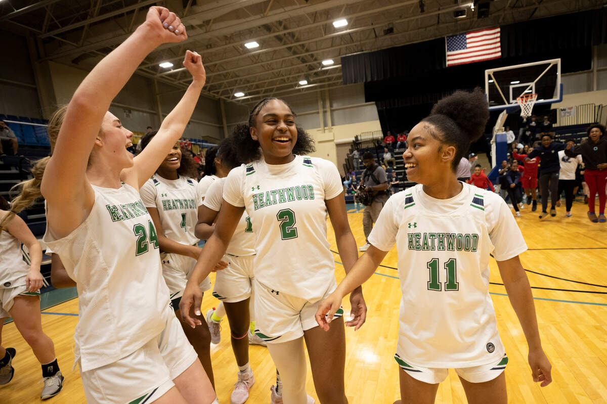 Virginia Bowers (24), Lauren Jacobs (2) and Amariea Spriggs (11) of Heathwood Hall celebrate their win over Northwood Academy at the Sumter County Civic Center in Sumter on Saturday, February 25, 2023.