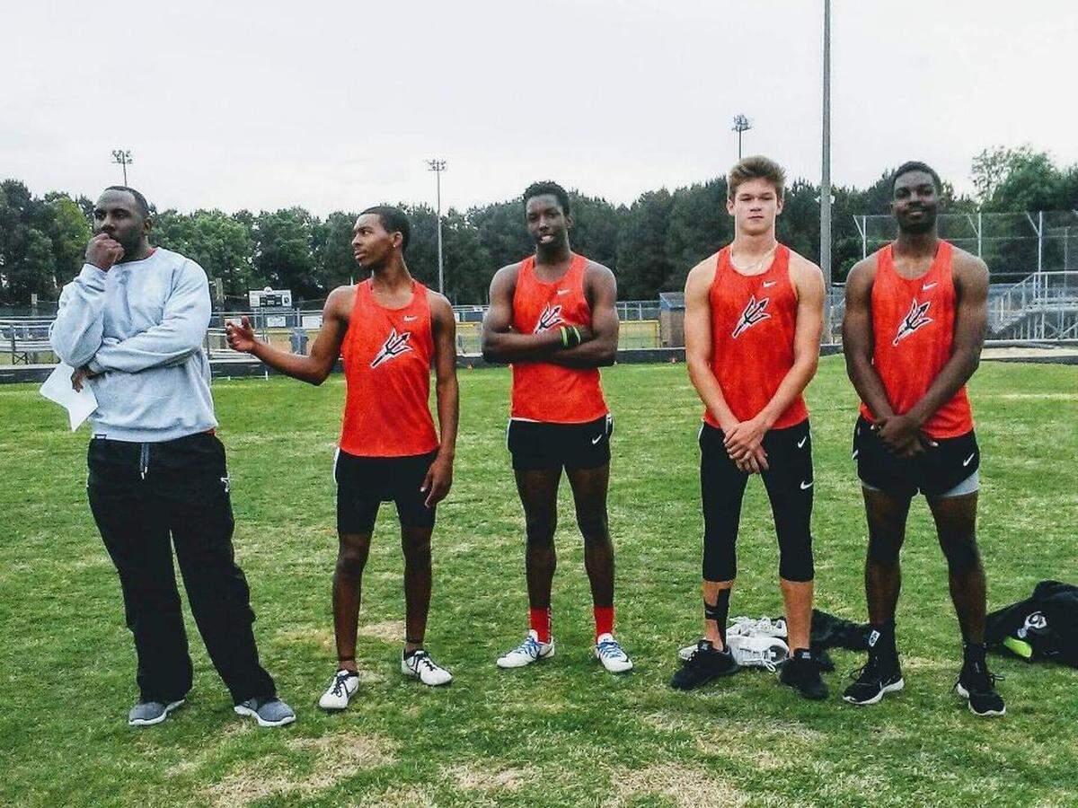 Former Clemson running back C.J. Spiller (left) stands with members of the Liberty track team.