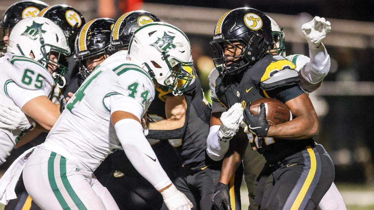 Amire White (28) of Irmo carries the ball as Jaden Wuerth (44) of Dutch Fork moves in for the tackle during Irmo’s game against visiting Dutch Fork in Columbia on Friday, October 31, 2025.