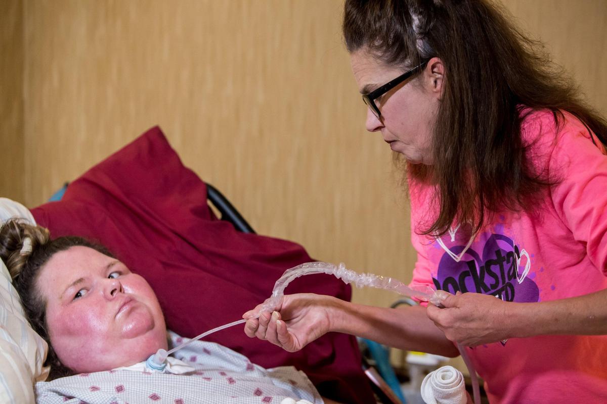 Jodie Roberts’ caretaker, Michelle Stevenson, tends to her. Roberts is in a vegetative state after being without oxygen for roughly twenty minutes while giving birth to her son in July 2018.