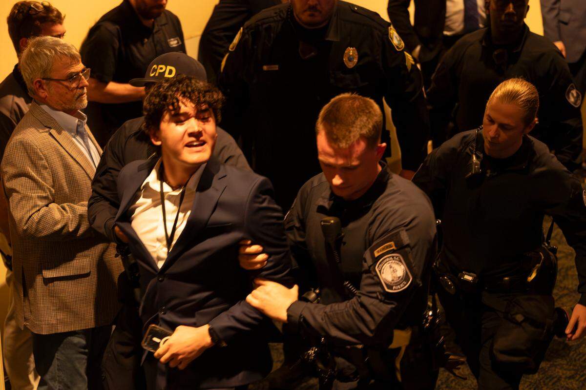 Police escort a person who disrupted President Joe Biden speaking during an appearance at the South Carolina Democratic Party’s First-in-the-Nation Celebration Dinner on Saturday, Jan. 27, 2024.