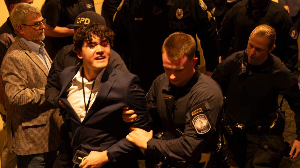 Police escort a person who disrupted President Joe Biden speaking during an appearance at the South Carolina Democratic Party’s First-in-the-Nation Celebration Dinner on Saturday, Jan. 27, 2024.