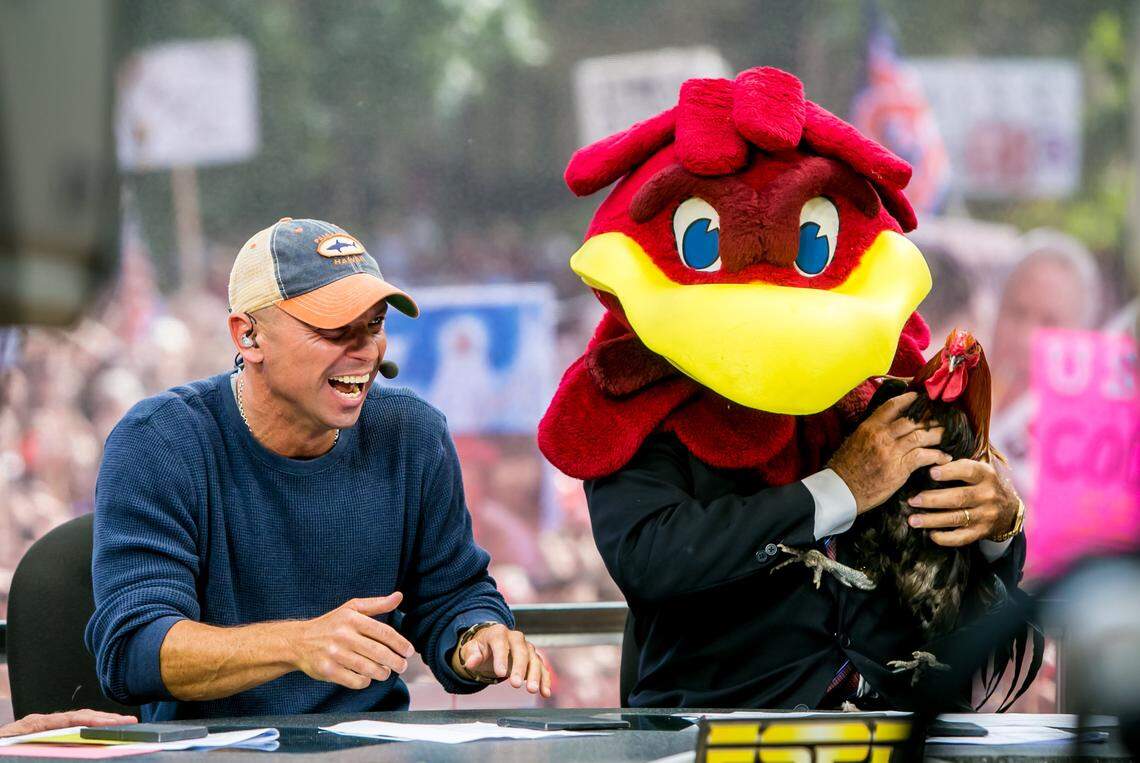 In this file photo Kenny Chesney looks on as Lee Corso dons the Gamecock headpiece and holds Sir Big Spur during ESPN’s College GameDay broadcast from the University of South Carolina.