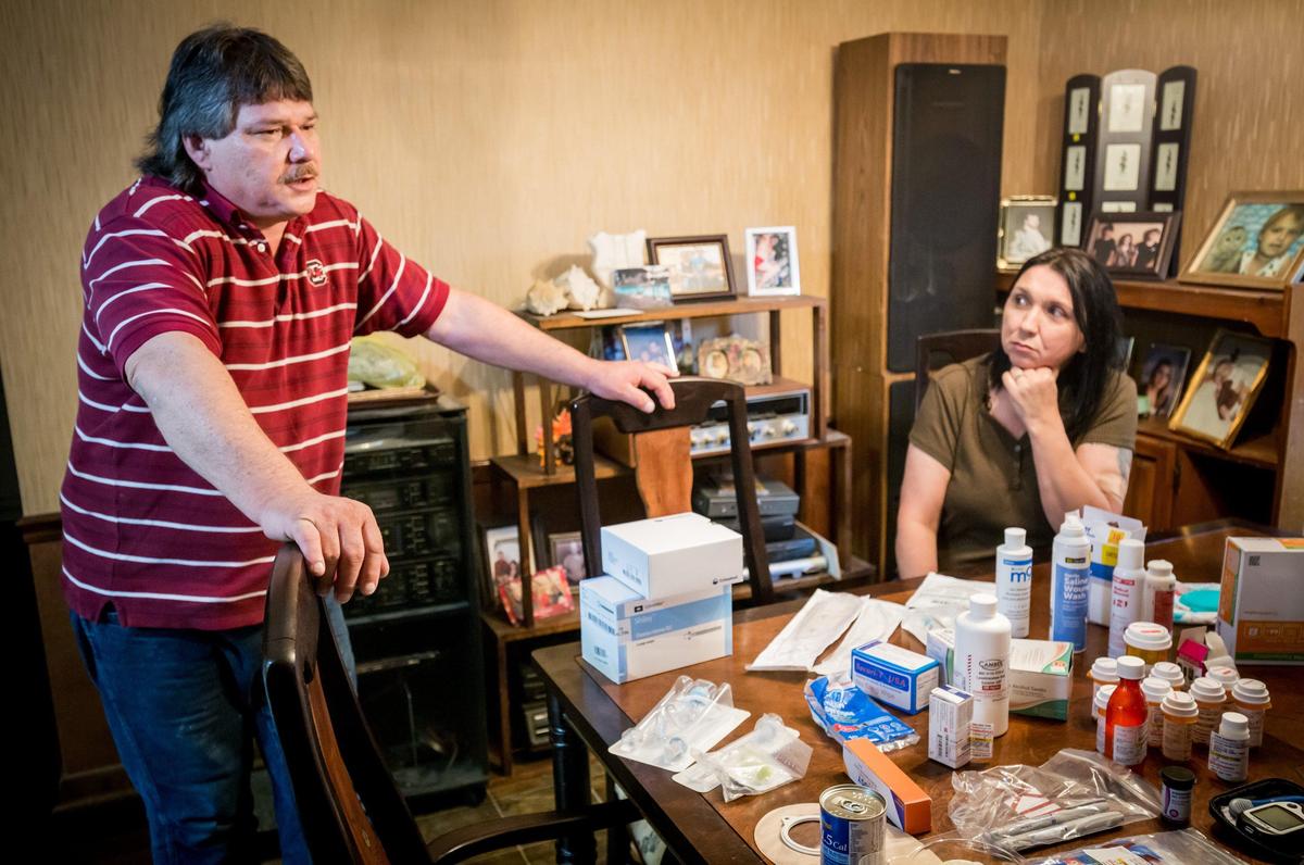 Burrell Kelly, Jodie Roberts’ uncle, and Becky Kelly, her aunt, talk near a table of medicine and other medical supplies for Roberts. She is in a vegetative state after being without oxygen for roughly twenty minutes while giving birth to her son in July 2018.