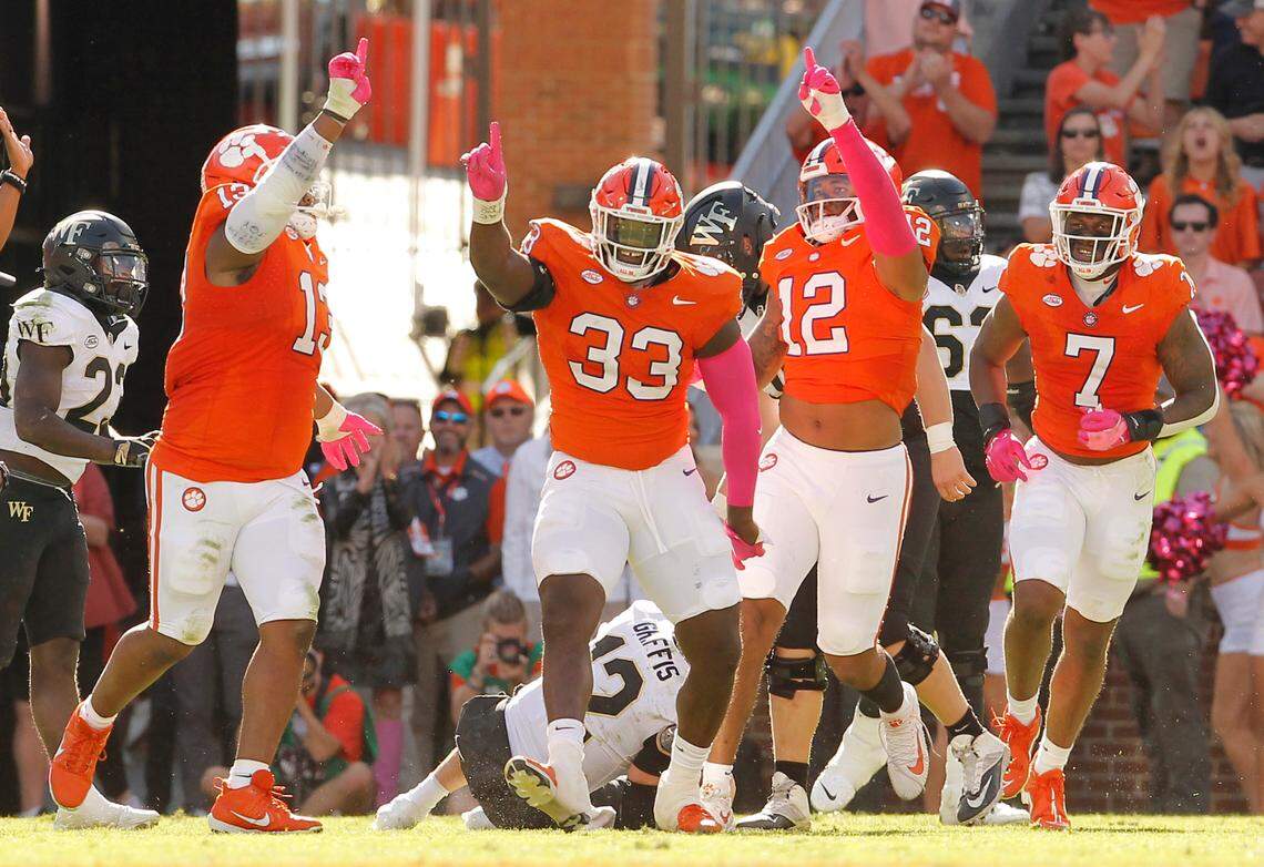 Clemson defensive tackle Ruke Orhorhoro (33) celebrates after taking down Wake Forest quarterback Mitch Griffis (12) during first-half action in Clemson, S.C. on Saturday, Oct. 7, 2023. (Travis Bell/SIDELINE CAROLINA)